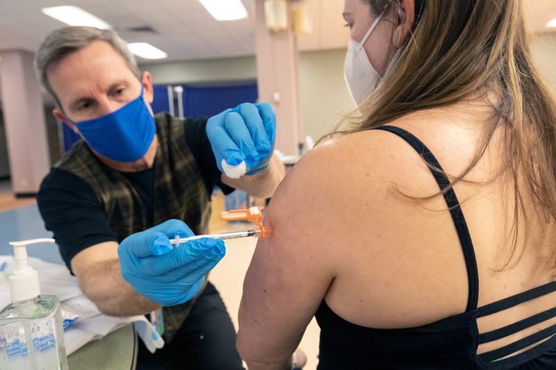 MPS teacher Jenny Aicher receives an immunization from City of Milwaukee health worker Steve Ohly at a mobile vaccination clinic, March 4, 2021 at All Saints Catholic Church, in Milwaukee. A $6.6 million grant awarded to the Milwaukee Health Department, used to expand COVID-19 vaccination, has been cancelled by President Donald Trump's administration.