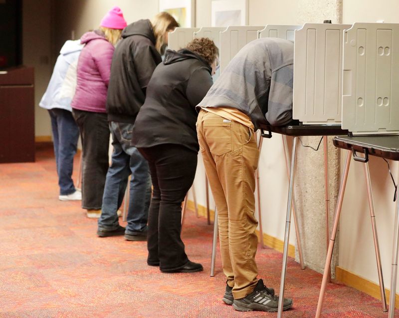 Voters line the booths at the Mead Public Library poll, Tuesday, April 1, 2025, in Sheboygan, Wis.