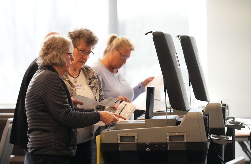 Poll workers processes absentee ballots for the spring election at the Brookfield Conference Center polling station in Brookfield, WI. on Tuesday, April 1, 2025.