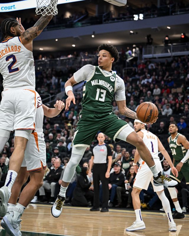 Milwaukee Bucks guard Ryan Rollins (13) saves a ball going out of bounds against the Phoenix Suns in a game Tuesday April 1, 2025, at Fiserv Forum in Milwaukee, Wisconsin.