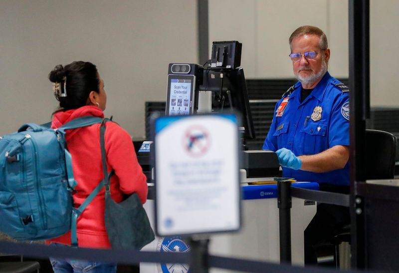 A Transportation Security Administration officer helps a passenger in 2025 at Green Bay Austin Straubel International Airport in Ashwaubenon.