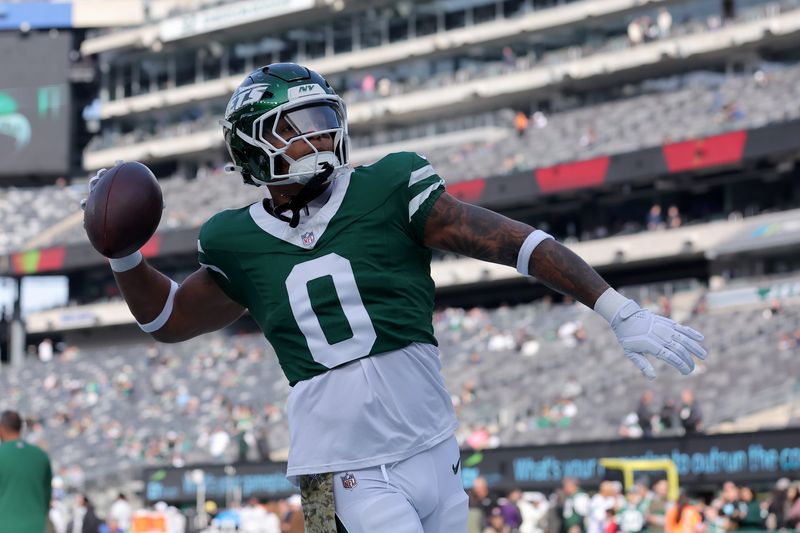 Nov 17, 2024; East Rutherford, New Jersey, USA; New York Jets running back Braelon Allen (0) plays catch with fans before a game against the Indianapolis Colts at MetLife Stadium. Mandatory Credit: Brad Penner-Imagn Images
