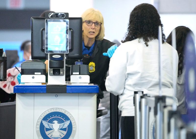 A passenger makes their way through TSA security screening at Milwaukee Mitchell International Airport in Milwaukee on Wednesday, May 7, 2025.