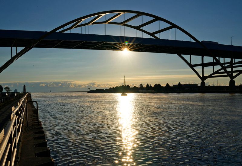 The sun rises behind the Hoan Bridge in Milwaukee, Wisconsin.