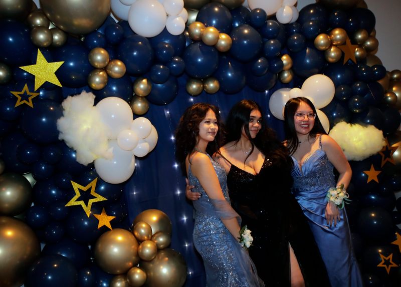 Kailee Xiong, left, Alexis Lauschke and Sophia Rattanasack , right, pose for a photo during the Under The Stars prom Saturday, May 10, 2025, at the Hilton Appleton Paper Valley hotel in downtown Appleton, Wisconsin. Students from Appleton North, Appleton East and Appleton West high schools attended the event.