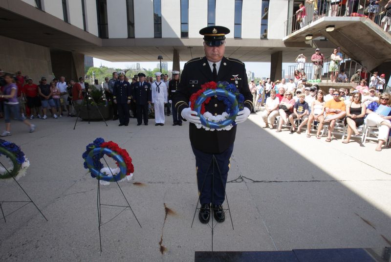 U.S. Army Sgt. Don Rask lays a wreath during the memorial wreath-laying ceremony at the Milwaukee County War Memorial after the 125th consecutive Memorial Day Parade in 2011.