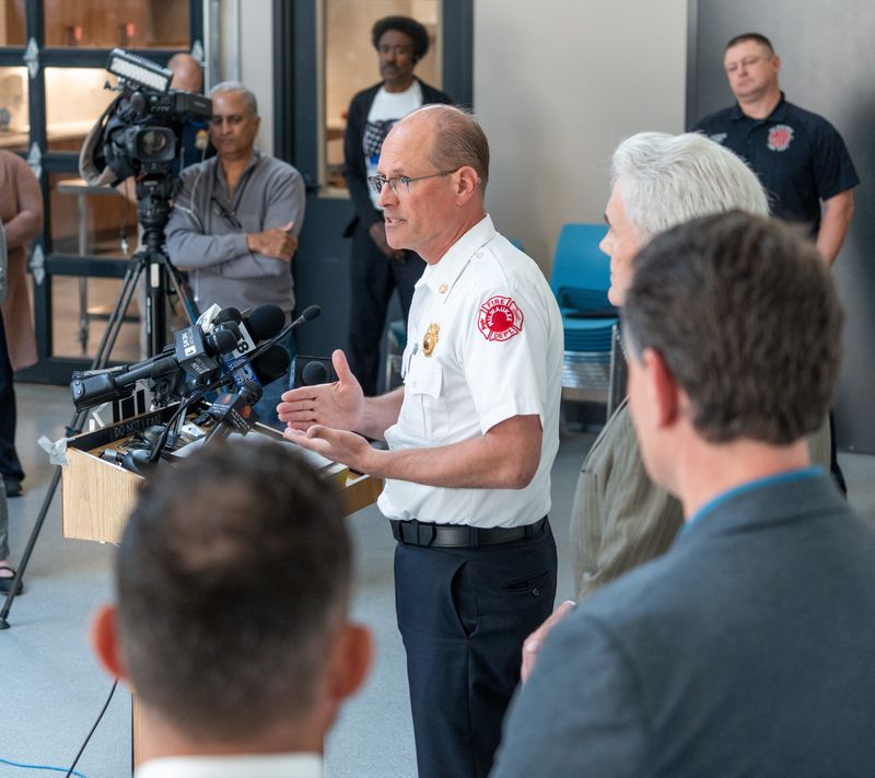 (Center) Milwaukee Fire Chief Aaron Lipski makes remarks regarding the Highland Court Apartments fatal fire at a press conference on Tuesday May 13, 2025 at Concordia 27 in Milwaukee, Wis.