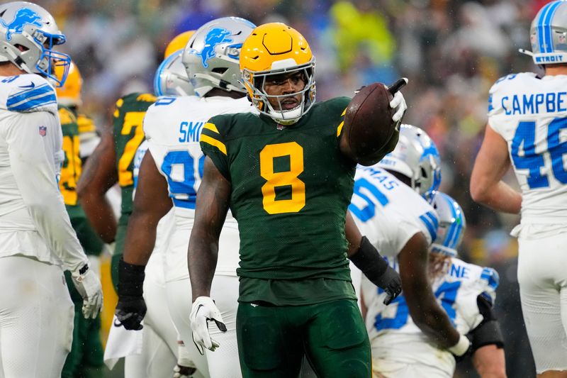 Nov 3, 2024; Green Bay, Wisconsin, USA; Green Bay Packers running back Josh Jacobs (8) gestures after earning a first down during the first quarter against the Detroit Lions at Lambeau Field. Mandatory Credit: Jeff Hanisch-Imagn Images