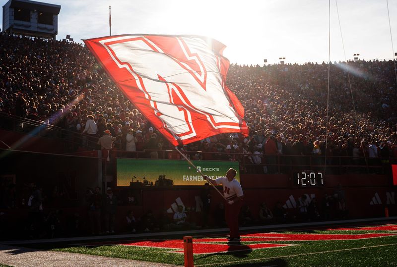 Nov 23, 2024; Lincoln, Nebraska, USA; The Nebraska Cornhuskers flag is waved after a touchdown against the Wisconsin Badgers during the first quarter at Memorial Stadium. Mandatory Credit: Dylan Widger-Imagn Images