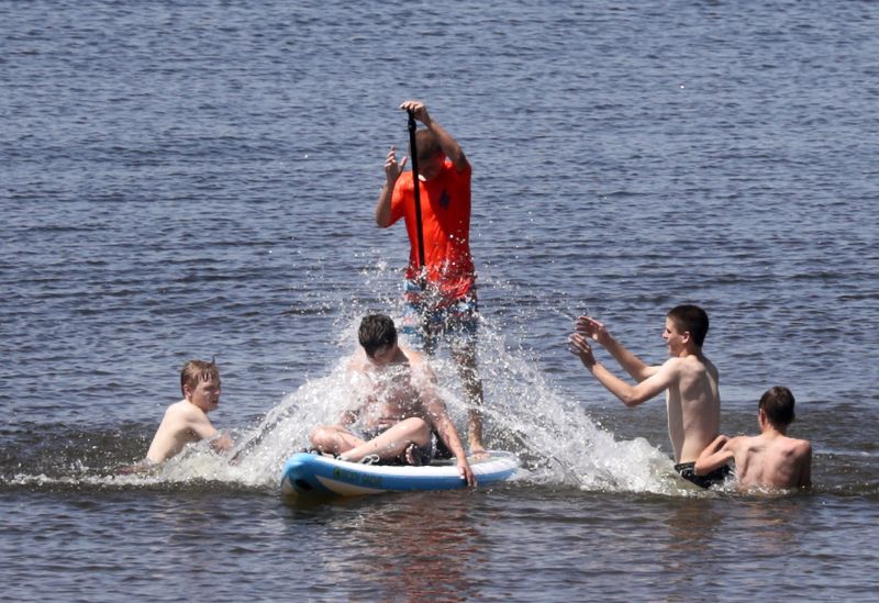 A group of young men enjoy the water near the High Cliff State Park beach on Lake Winnebago on June 30, 2020, in Sherwood, Wisconsin
