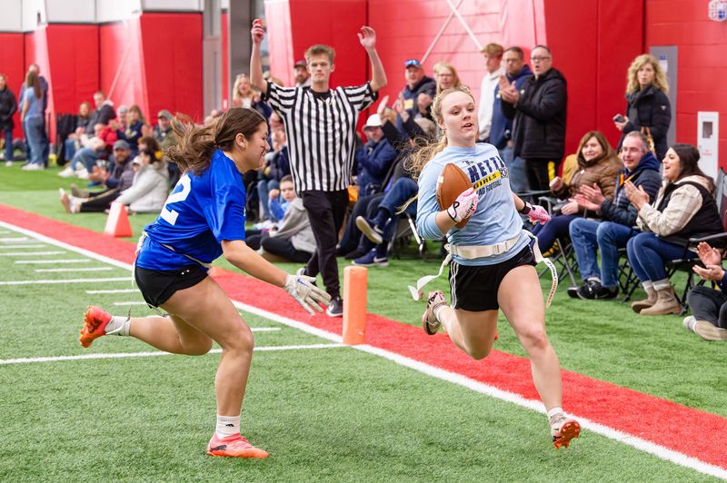 Kettle Moraine's Riley Vertz scores a touchdown against Catholic Memorial in a girls high school flag football game during the 2024-25 school year at Muskego High School. The teams were part of a conferece of club teams loosely centered around the Classic 8 Conference.
