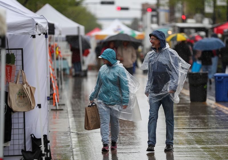 Ann and Joe Sargent walk through the Farmers Market on Broadway on May 21 along Broadway in Green Bay.