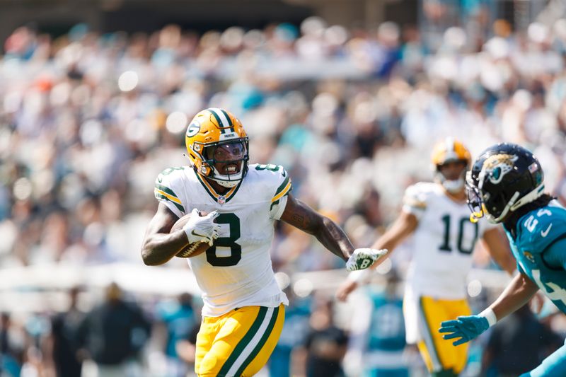 Oct 27, 2024; Jacksonville, Florida, USA; Green Bay Packers running back Josh Jacobs (8) runs the ball against the Jacksonville Jaguars during the second quarter at EverBank Stadium. Mandatory Credit: Morgan Tencza-Imagn Images