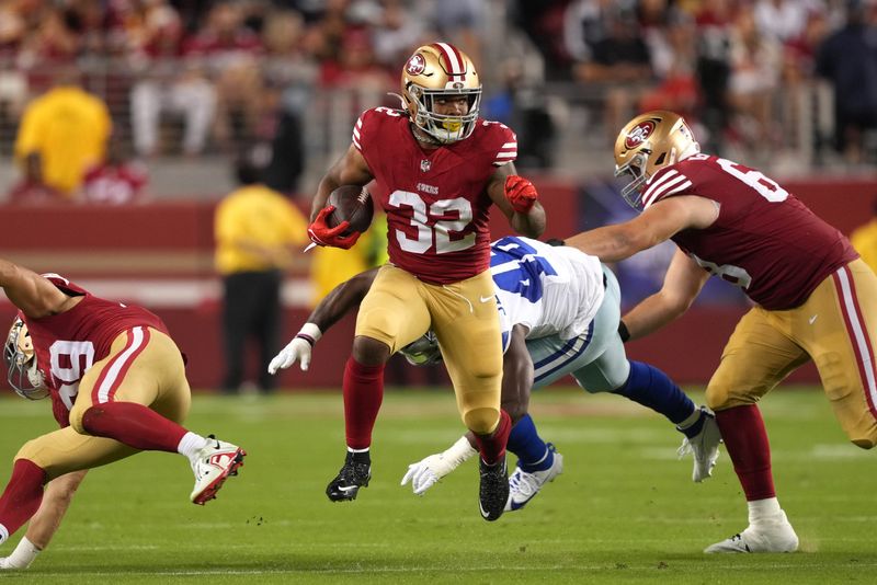Oct 8, 2023; Santa Clara, California, USA; San Francisco 49ers running back Tyrion Davis-Price (32) carries the ball against Dallas Cowboys linebacker Malik Jefferson (46) as offensive tackle Colton McKivitz (right) blocks during the fourth quarter at Levi's Stadium. Mandatory Credit: Darren Yamashita-USA TODAY Sports