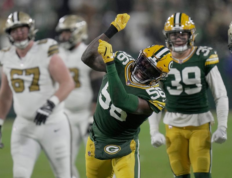 Dec 23, 2024; Green Bay, Wisconsin, USA; Green Bay Packers linebacker Edgerrin Cooper (56) celebrates a tackle for a three-yard loss during the second quarter against the New Orleans Saints at Lambeau Field. Mandatory Credit: Mark Hoffman/Milwaukee Journal Sentinel/Imagn Images
