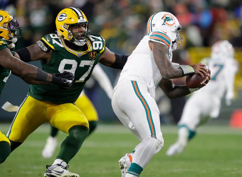 Green Bay Packers defensive tackle Kenny Clark (97) sacks Miami Dolphins quarterback Tua Tagovailoa (1) during their football game Thursday, November 28, 2024, at Lambeau Field in Green Bay, Wisconsin. 
Dan Powers/USA TODAY NETWORK-Wisconsin.