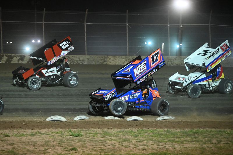 Sheldon Haudenschild bounces over the tires marking the edge of the track during the 2025 World of Outlaws sprint car feature at the Plymouth Dirt Track.