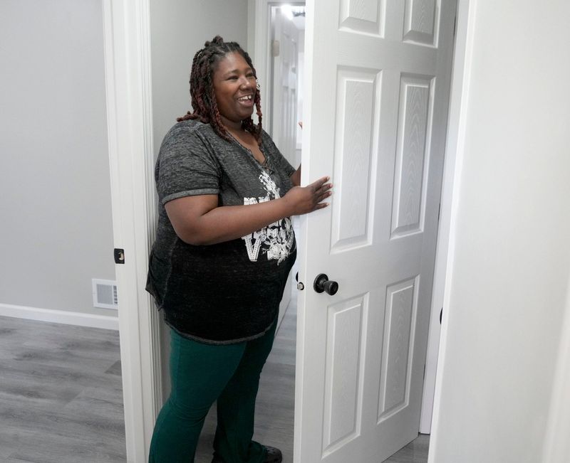 Danielle Terrell looks in a closet of a newly refinished home she’ll soon be living in during an event celebrating the purchasing and rehabilitation of city-owned homes in the Metcalfe Park neighborhood on North 36th Street in Milwaukee on June 12, 2025.