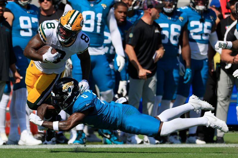 Jacksonville Jaguars safety Darnell Savage (6) tackles Green Bay Packers running back Josh Jacobs (8) on a play that was called back for an offensive penalty during the first quarter of an NFL football matchup Sunday, Oct. 27, 2024 at EverBank Stadium in Jacksonville, Fla. The Packers edged the Jaguars 30-27 on a last-second field goal. [Corey Perrine/Florida Times-Union]