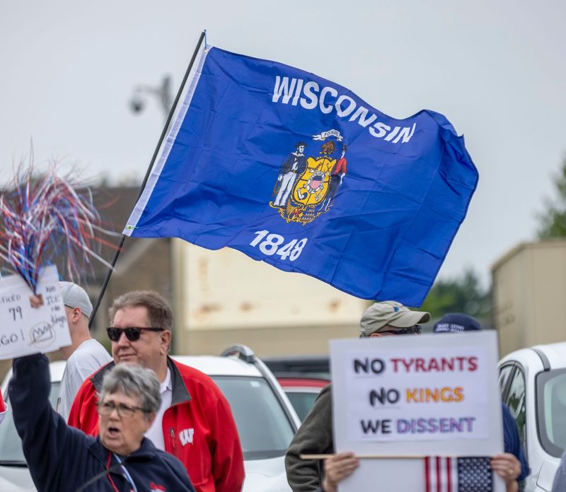 The Stevens Point No Kings rally is held near the United States Postal Office in Stevens Point, Wis., on Saturday, June 14, 2025. The rally lined both sides of the street from Strongs Street to Prentice Street as cars drove consistently through honking and cheering. Toward the end, the demonstrators looped the block, nearly lining the entire march route.