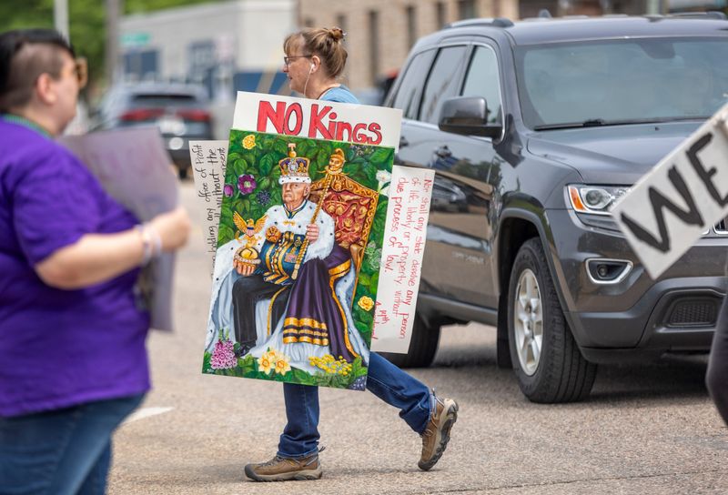 The Stevens Point No Kings rally is held near the United States Postal Office in Stevens Point, Wis., on Saturday, June 14, 2025. The rally lined both sides of the street from Strongs Street to Prentice Street as cars drove consistently through honking and cheering. Toward the end, the demonstrators looped the block, nearly lining the entire march route.