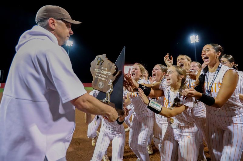 Kaukauna players celebrate with the trophy after beating Kenosha Bradford 1-0 in the WIAA Division 1 state softball championship game June 14 in Madison.