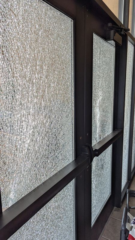 Damaged windows and doors of the Temple Menorah building