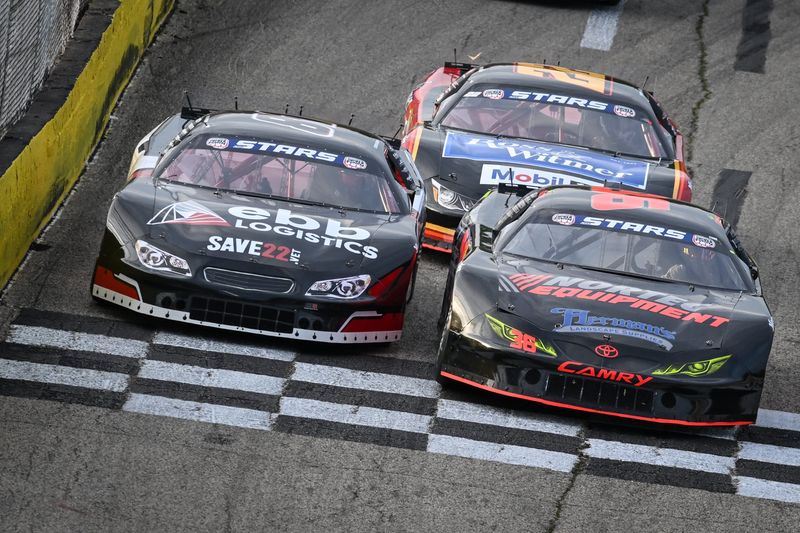 Carson Brown, left, Ty Fredrickson, right front, and George Phillips race down the front stretch during the 2025 El Bandido Yankee Tequila 300  at Slinger Speedway. Brown returns as the 2026 points leader.