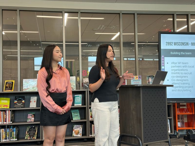 HAPA seniors Pachai Vang and Ashley Vang speak about their projects during the "Rooted Voices: Hmong Stories from the Heart of Milwaukee" event hosted by The Hmong American Peace Academy on June 12, 2025.