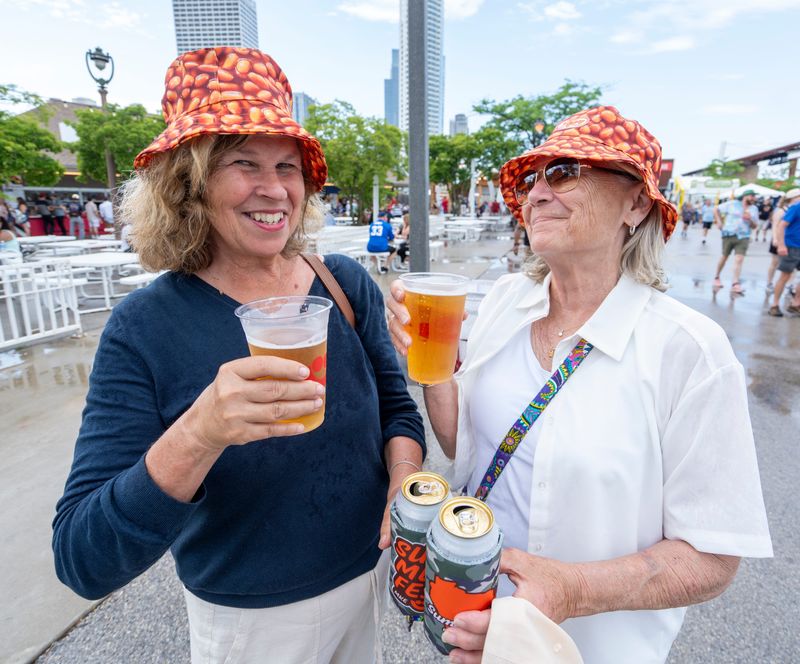 (Left) Julie Schlabach and (right) Kelly Whelpley enjoy their drinks during the opening day of Summerfest at the Henry Maier Festival Park in Milwaukee on June 19, 2025.