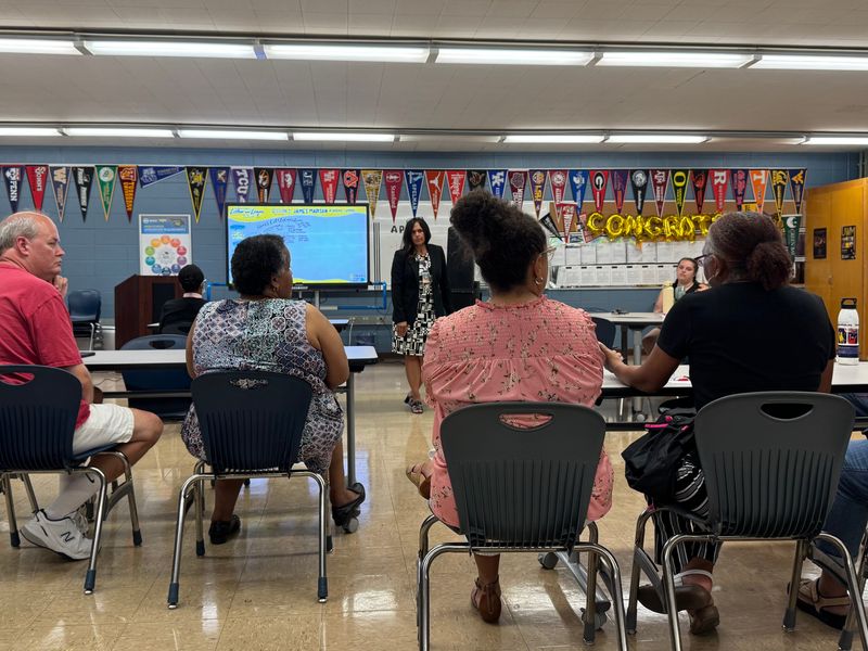 Milwaukee Public Schools Superintendent Brenda Cassellius, center, listens as Sharonda Robinson describes efforts to improve the play area at Stuart School, where she works as the coordinator of the International Baccalaureate Primary Years Programme.