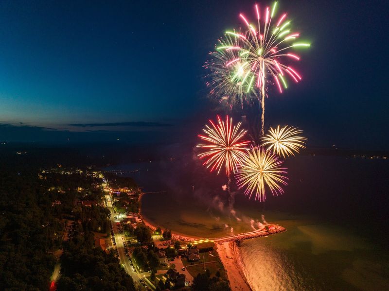 Fireworks light up the night sky over Anclam Park on the Lake Michigan shoreline in Baileys Harbor during the community's 2024 Fourth of July Celebration. The 2025 event, which includes a parade, Strawberry Fest and an arts and crafts fair along with fireworks, again takes place July 4.