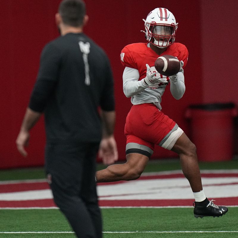 Nate White catches a pass during 2024 spring football practice in Madison.