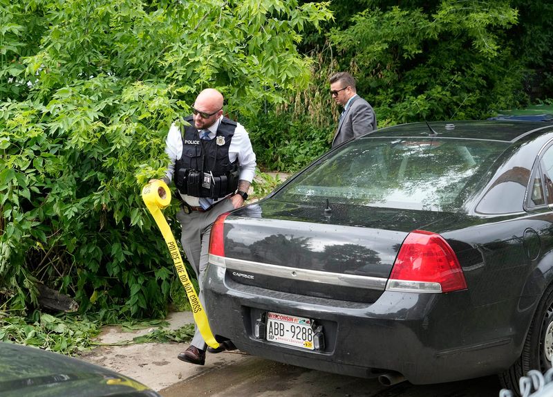 Investigators work at the scene of a police shooting that injured two Milwaukee police officers near North 24th Street and West Garfield Avenue in Milwaukee on June 27, 2025.