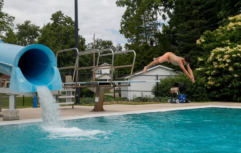Greyson Coughlin, 8, dives from a diving board on Friday, June 27, 2025, at the Resch Aquatic Center in Green Bay, Wis. 
Tork Mason/USA TODAY NETWORK-Wisconsin