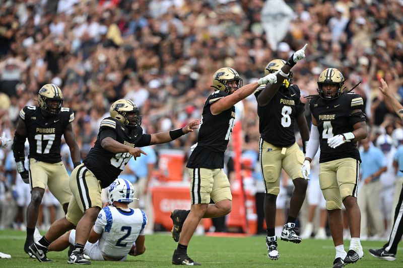 Aug 31, 2024; West Lafayette, Indiana, USA; Purdue Boilermakers defensive end Will Heldt (15) and defensive end CJ Madden (8) celebrate sacking Indiana State Sycamores quarterback Elijah Owens (2) during the second half at Ross-Ade Stadium. Mandatory Credit: Marc Lebryk-USA TODAY Sports