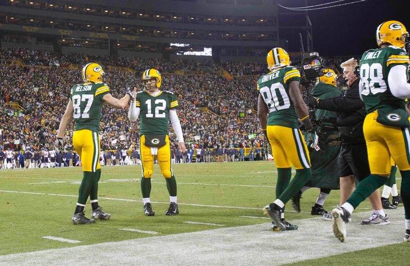 Dec 25, 2011; Green Bay, WI, USA; Green Bay Packers wide receiver Jordy Nelson (87) (left) is congratulated by quarterback Aaron Rodgers (12) (right) after catching a touchdown pass during the third quarter against the Chicago Bears at Lambeau Field. The Packers defeated the Bears 35-21. Mandatory Credit: Jeff Hanisch-USA TODAY Sports