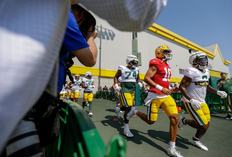 Green Bay Packers quarterback Jordan Love (10) runs onto the practice field for his first practice of training camp on Saturday, July 27, 2024, at Ray Nitschke Field in Ashwaubenon, Wis. Love signed a four-year, $220 million contract extension on Friday after sitting out of the first four team practices while his extension was being negotiated.