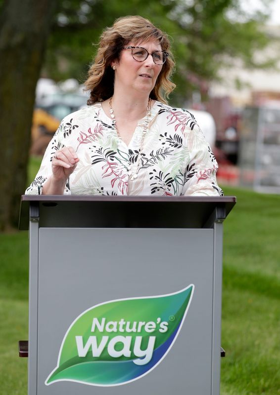 Christine Greer, Nature’s Way senior vice president of supply chain operations, speaks on July 9 about the company's new geothermal heating and cooling project at the Challenger Drive facility in Green Bay.