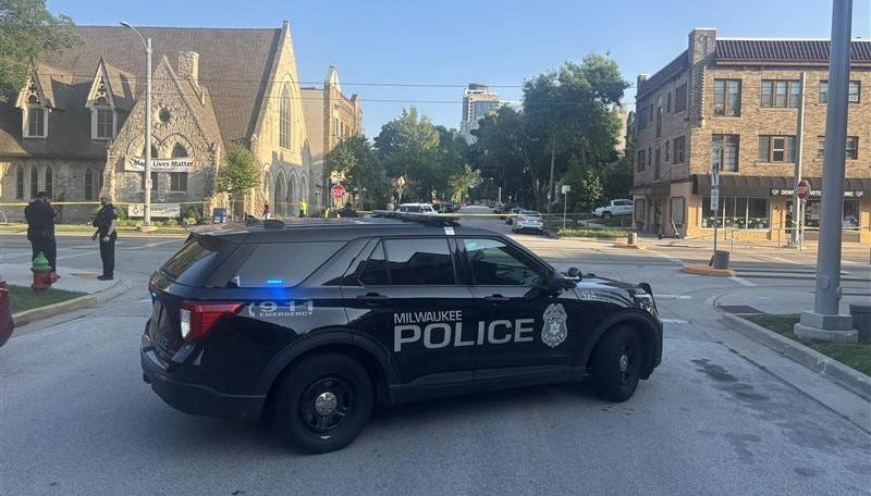 Milwaukee police officers work at the scene of crash where a bicyclist was critically injured at the intersection of East Ogden Avenue and North Astor Street on July 9.