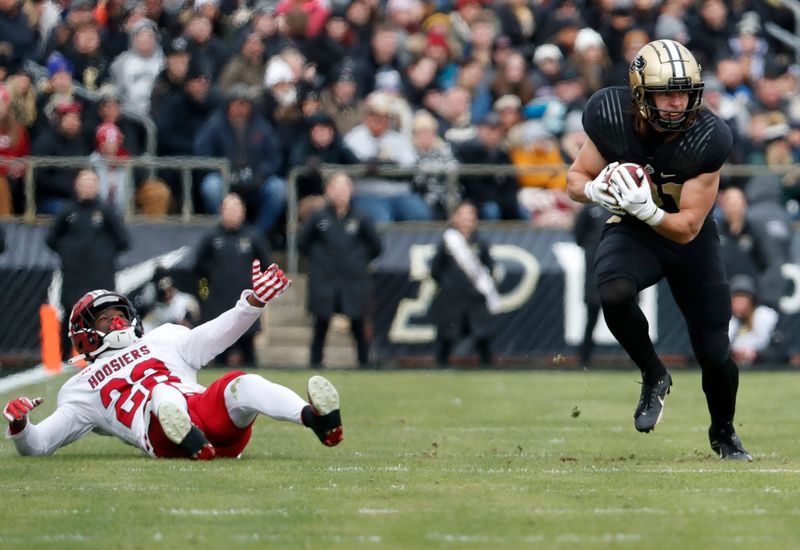 Purdue Boilermakers tight end George Burhenn (81) breaks the tackle of Indiana Hoosiers defensive back Jamari Sharpe (22) during the NCAA football game, Saturday, Nov. 25, 2023, at Ross-Ade Stadium in West Lafayette, Ind.