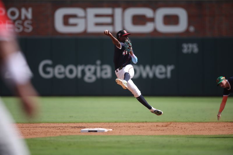 Jul 12, 2025; Atlanta, GA, USA; National League infielder Jesus Made (12) of the Milwaukee Brewers catches and throws a pass during the third inning against American League at Truist Park. Mandatory Credit: Brett Davis-Imagn Images