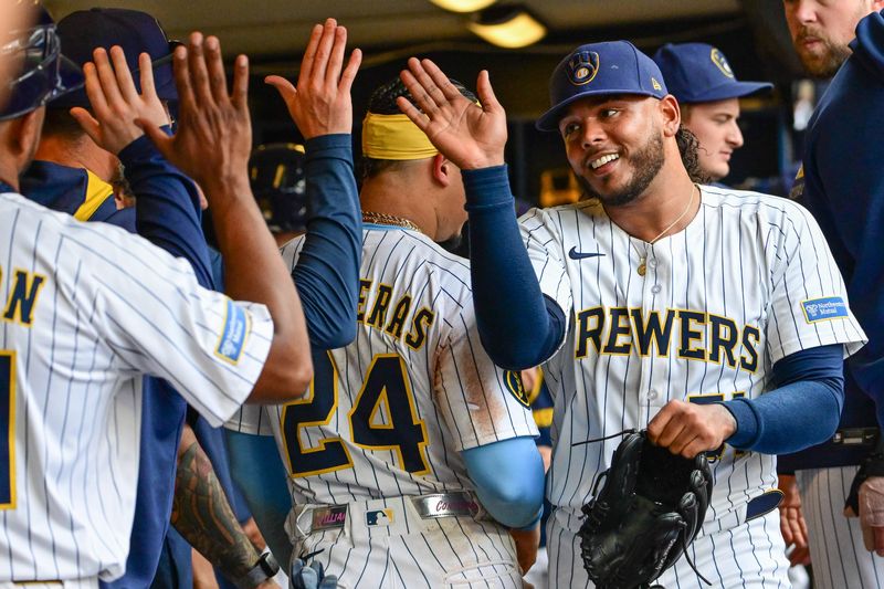 Jul 13, 2025; Milwaukee, Wisconsin, USA; Milwaukee Brewers starting pitcher Freddy Peralta (51) is greeted in the dugout after pitching six plus innings against the Washington Nationals at American Family Field. Mandatory Credit: Benny Sieu-Imagn Images