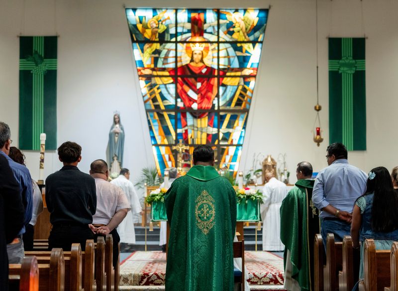 Fr. Javier Bustos, center, processes to the altar at the start of the Mass at Our Lady Queen of Peace Catholic Church on Saturday, July 12, 2025, in Milwaukee, Wisconsin.
