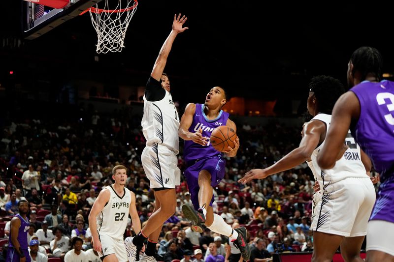 Jul 14, 2025; Las Vegas, NV, USA; Utah Jazz forward John Tonje (17) drives towards the basket against San Antonio Spurs forward Carter Bryant (11) during the first half of a NBA basketball game at the Thomas & Mack Center. Mandatory Credit: Lucas Peltier-Imagn Images