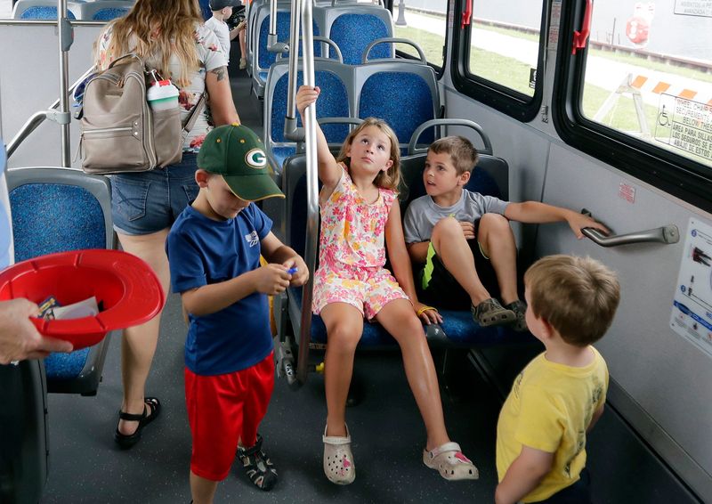 Children check out the insides of a city bus during Touch the Trucks, sponsored by the Manitowoc Public Library, Wednesday, July 16, 2025, in Manitowoc, Wis.