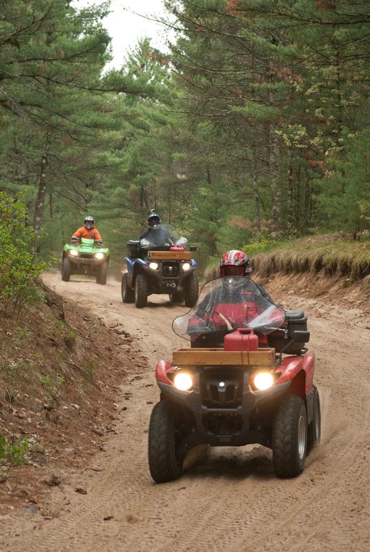 ATVs make their way through the Black River State Forest in Jackson County.