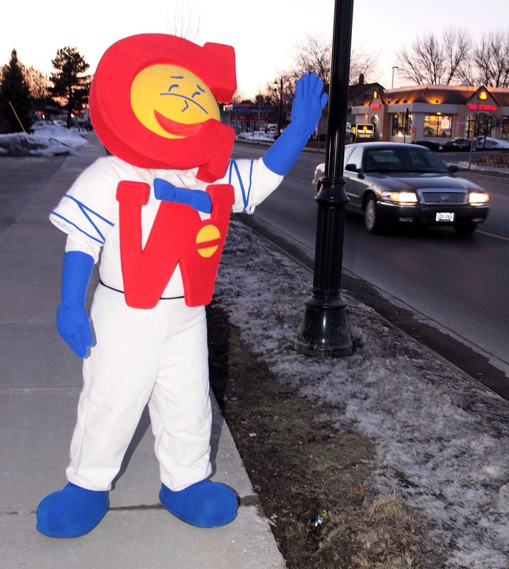 Bethany Brown from Oconomowoc plays George Webb as she waves to traffic in front of the George Webb Restaurant in Oconomowoc on March 3, 2010, during a "Spring Training Warm-Up" promotion, all 38 Wisconsin locations of George Webb Restaurants offered 6 hamburgers to every patron who donated 5 non-perishable food items to the Hunger Task Force.