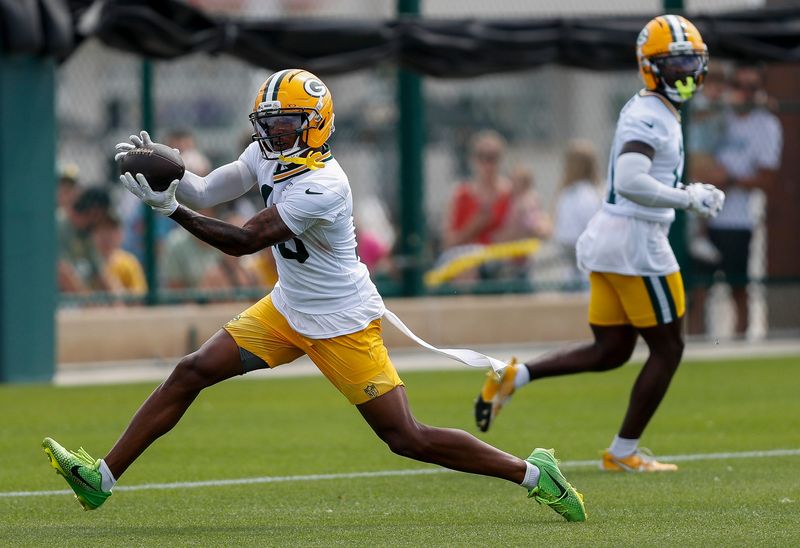 Green Bay Packers wide receiver Dontayvion Wicks (13) catches a pass during the first day of training camp on Wednesday, July 23, 2025, at Ray Nitschke Field in Ashwaubenon, Wis. 
Tork Mason/USA TODAY NETWORK-Wisconsin