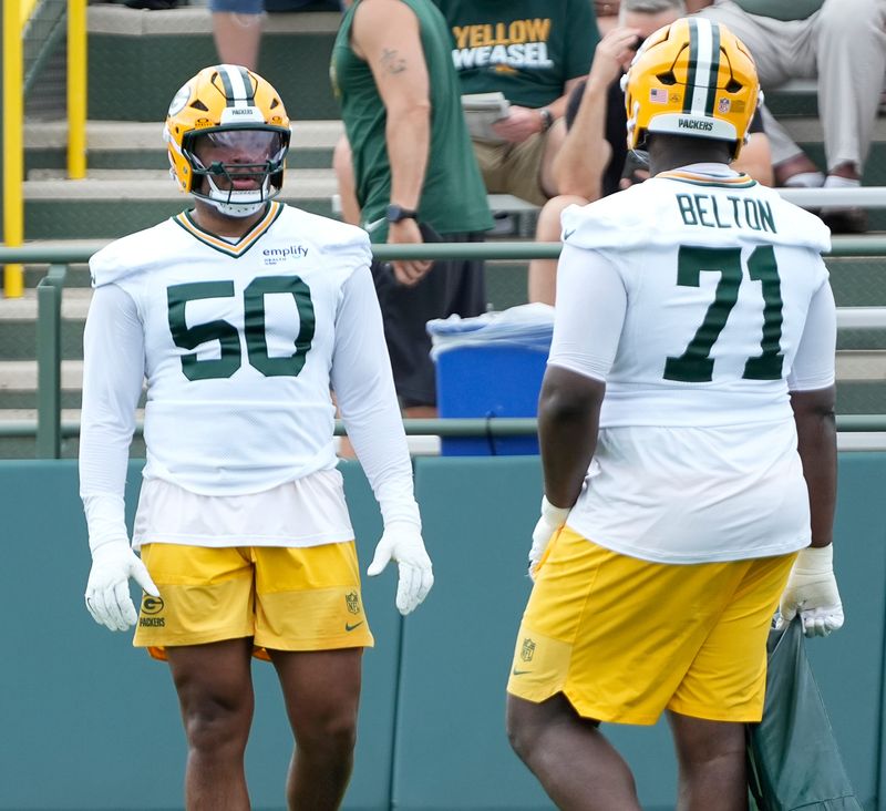 Green Bay Packers offensive tackle Zach Tom (50) and offensive tackle Anthony Belton (71) run through a drill during the second day of training camp on Thursday, July 24, 2025, at Ray Nitschke Field in Ashwaubenon, Wis.